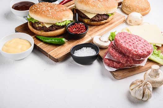 Burger with beef for grill on white background with copy space.