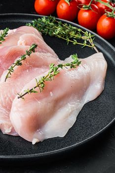 Raw chicken meat cuts, on black background