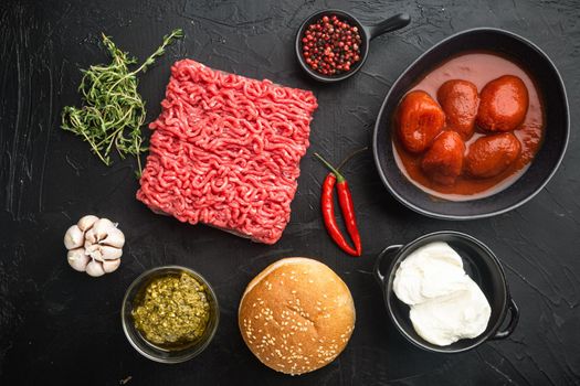Fresh raw minced beef steak burgers with spices ingredients set, on black stone background, top view flat lay