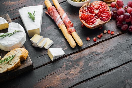 Classic italian antipasti set, on dark wooden background with copy space for text