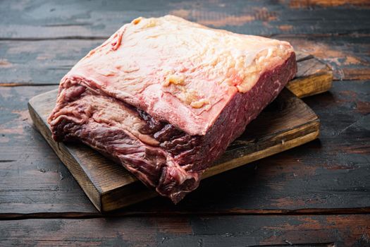 Sirloin steak, uncooked beef meat cut, on dark wooden background