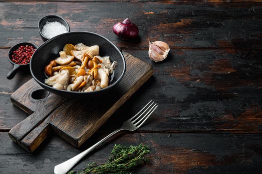 Canned mushrooms in oil set, on old dark wooden table background , with space for text copyspace