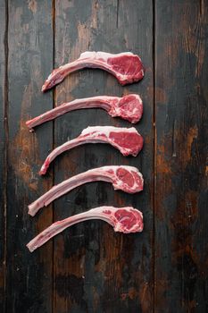 Raw fresh lamb loin chops set, on old dark wooden table background, top view flat lay
