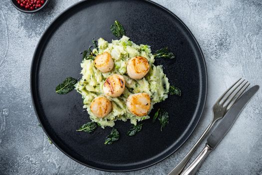 Sea delicacies, scallops cooked with minty puree, flat lay, on grey background