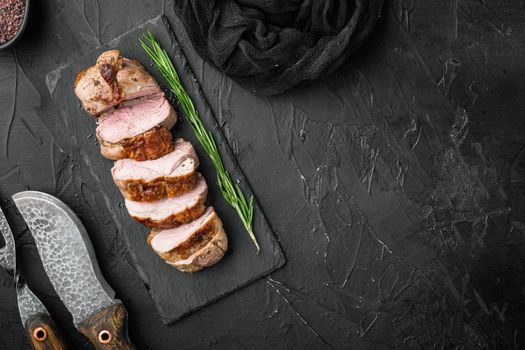 Grilled duck meat set, on stone serving board, on black stone background, top view flat lay, with copyspace and space for text