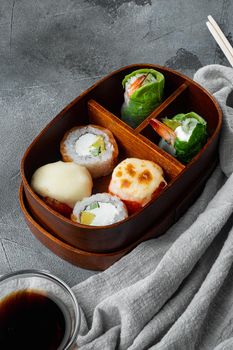 Japanese bento lunch box with chopsticks set, on gray stone background