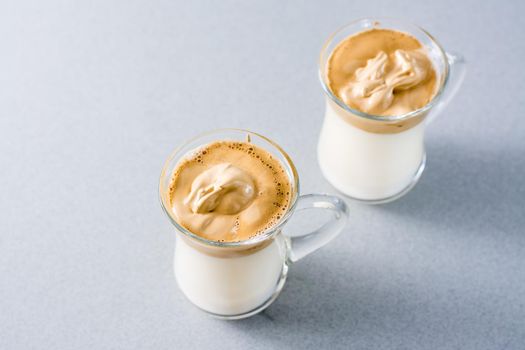 Quarantine trendy cuisine. Two cups with dalgona coffee on a gray background.