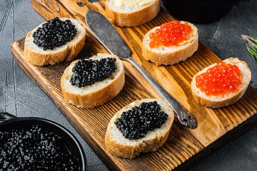 Sandwiches with red and black caviar baguette, on gray background