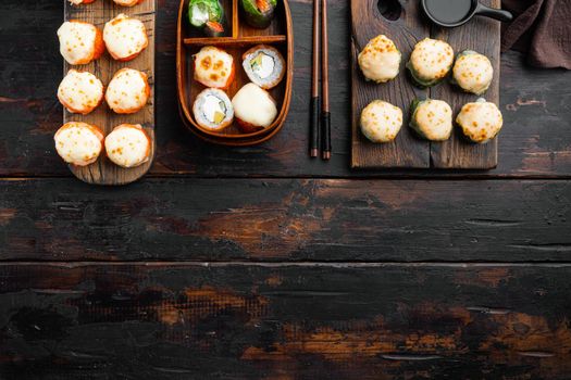 Fresh Sushi rolls with wasabi and ginger set, on old dark wooden table background, top view flat lay , with copyspace and space for text