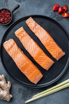 Fish patties ingredient with salmon and lemongrass, on grey background, top view