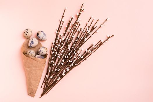 Happy Easter. Package with quail eggs and pussy willow bouquet on pink background