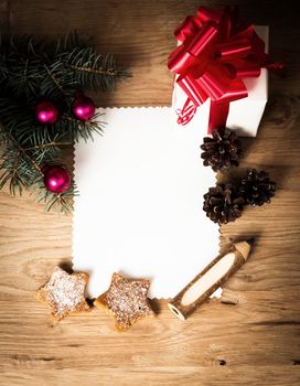 Christmas card: blank, vintage rural gift and Christmas tree branch on wooden background with gift