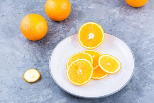 Pieces of fresh orange on a plate on the table. Vitamins, diet and vigor. Healthy eating