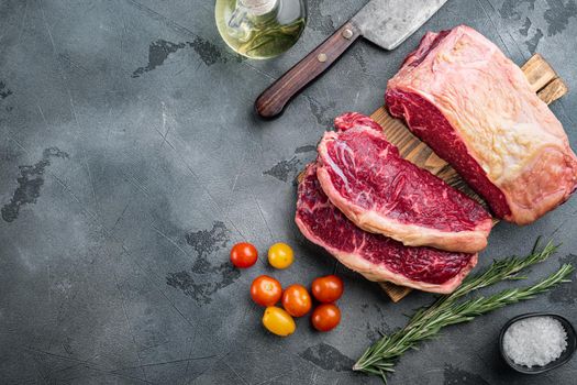 Kansas city raw organic beef steak cut, on gray background, top view, with copy space for text