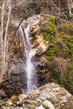 Autumn waterfall with rocks and leaves in Troodos mountains in Cyprus.