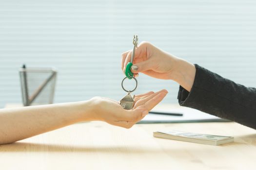 Business, realtor and real estate concept - Hand-to-hand key from new home.