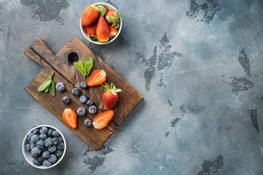 Fresh summer berrie, on gray background, top view flat lay with copy space for text