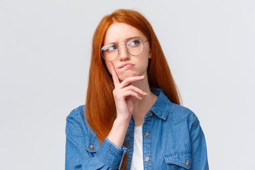 Close-up thoughtful and focused, creative female freelancer, student want work part-time, thinking opportunities, look away smirk and frowning pondering, make decision, stand white background.