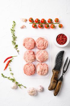 Semi finished products, meatballs, meat patties in plastic pack set, on white stone table background, top view flat lay