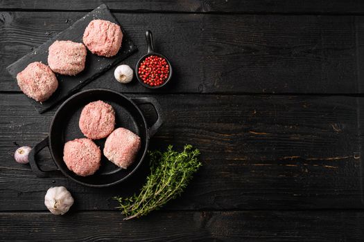 Raw minced meat made into meatballs set, on black wooden table background, top view flat lay, with copy space for text