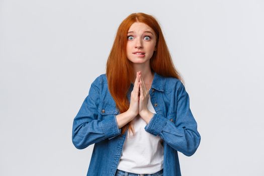 Waist-up portrait nervous redhead female student need help asap, hold hands over chest together in pray, smiling worried and impatient stare camera, pleading, begging favour.