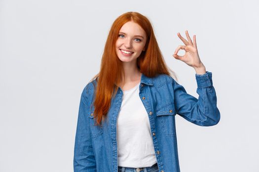 Teamwork, communication and people concept. Supportive good-looking female team member, girl coworker showing okay gesture and smiling with approval, agree or like something, white background.
