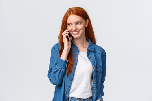 Girl calling boyfriend pick her up after classes. Attractive outgoing redhead woman talking on phone, smiling carefree, look away as having casual conversation on smartphone, white background.