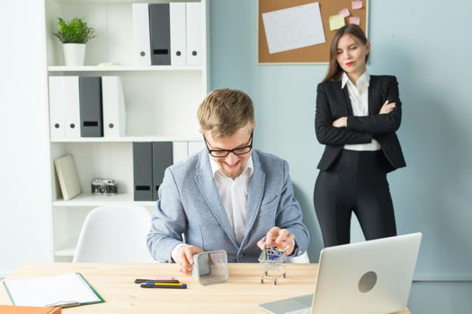 Business, emotions and people concept - Disgruntled boss watch as the employee works