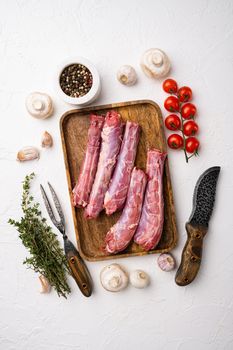 Duck necks raw, freshly set, on white stone table background, top view flat lay, with copy space for text