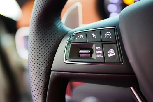 Close up steering wheel with multi function button. Luxury car interior.