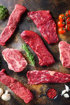 Variety, of raw beef steaks flap flank Steak, machete steak or skirt cut, Top blade or flat iron beef and tri tip, triangle roast with denver cut top view over old rustic metal surface