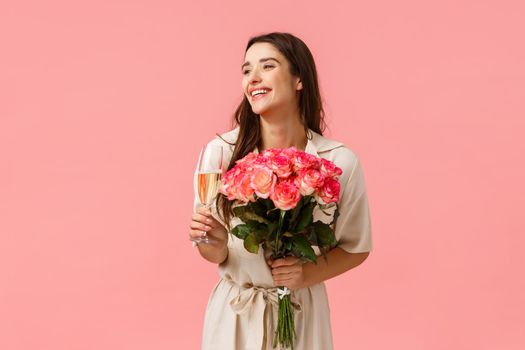 Elegance, romance and valentines day concept. Woman celebrating birthday, having fun, enjoying party, holding champagne glass, drinking and laughing, receiving beautiful bouquet flowers.