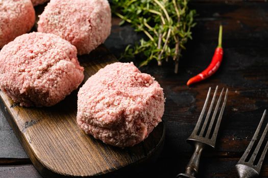Home made raw meatballs set, on old dark wooden table background