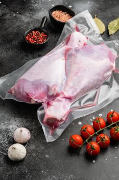 Turkey legs vacuum pack set, on black dark stone table background