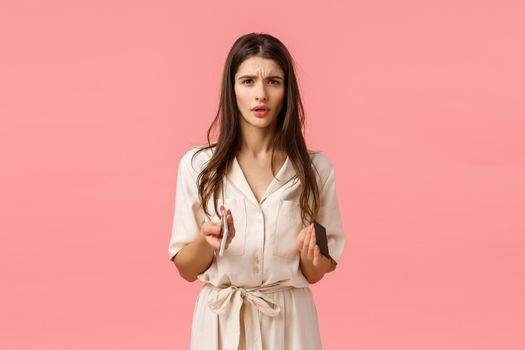 Finance, technology concept. Troubled and worried young frustrated woman cant understand what happened, frowning looking perplexed and cocnerned, holding credit card with smartphone, pink background.