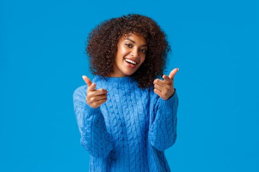 You cool, good job congratulations. Lucky cute african-american female with afro haircut, winter sweater, tilt head lovely smiling and pointing fingers camera as seeing friend and encourage her.
