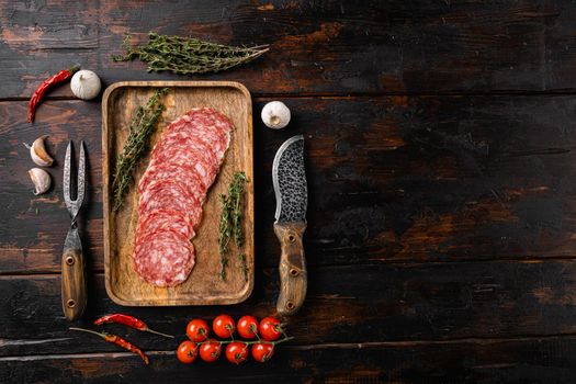 Smoked Sausage Slices Salami set, on old dark wooden table background, top view flat lay, with copy space for text