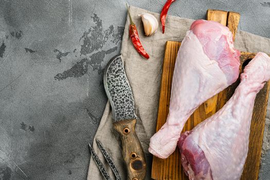 Raw turkey legs ingredients set, on wooden cutting board, on gray stone table background, top view flat lay, with copy space for text