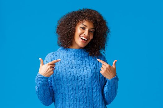 Girl got job, bragging and pointing herself boastful. Proud good-looking african american female in winter sweater, talking personal achievement and smiling satisfied, won prize become champion.