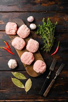 Fresh raw turkey meatballs set, on old dark wooden table background, top view flat lay