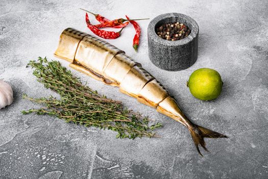 Smoked mackerel set, on gray stone table background, with copy space for text