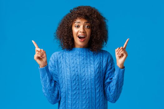 Wonderful and lovely thing, girl wants it, buy please. Silly and cute african-american woman with afro haircut asking for b-day gift, found shop with awesome best discounts, pointing fingers up.