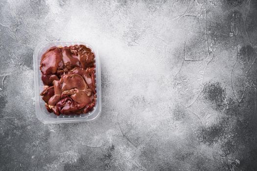 Fresh turkey industrial production, farm turkey liver in a vacuum set, on gray stone table background, top view flat lay, with copy space for text
