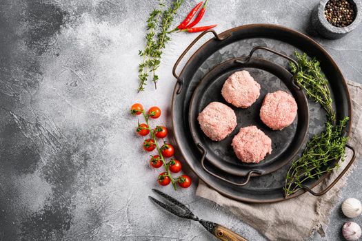 Raw burgers cutlets from organic meat set, on gray stone table background, top view flat lay, with copy space for text