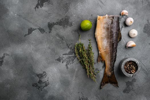 Smoked whole salmon set, on gray stone table background, top view flat lay, with copy space for text