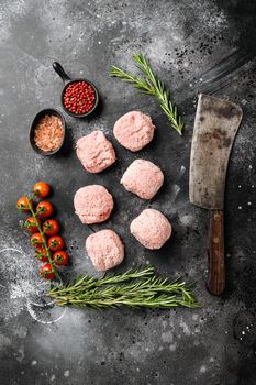 Fresh raw turkey meatballs set, on black dark stone table background, top view flat lay