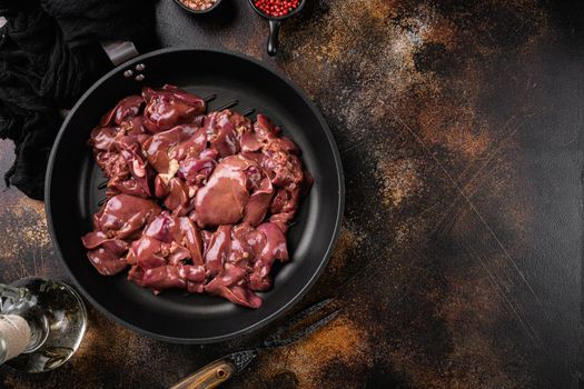 Raw chicken liver set, on old dark rustic table background, top view flat lay, with copy space for text