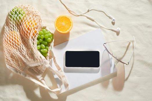 Phone, camera, fruit, bag, notebook and accessories, top view, Flat lay, The concept of a picnic, summer