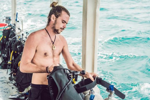 Diver prepares his equipment for diving in the sea.