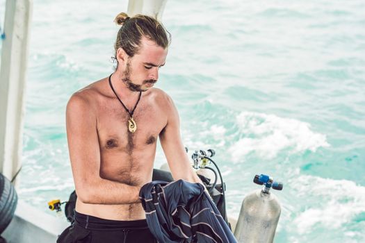 Diver prepares his equipment for diving in the sea.